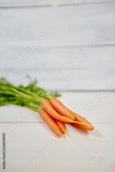 Obraz carrots on white wooden background