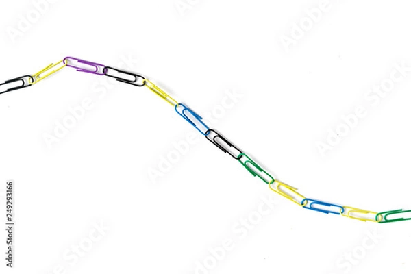 Obraz colorful paper clips chain in form of snake on the table surface