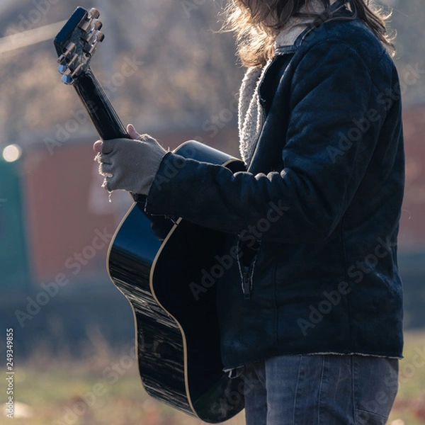 Obraz Guy plays guitar in park