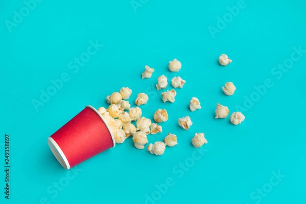 Fototapeta Pop corn on pastel color background.Food and snack concepts ideas.Minimal
