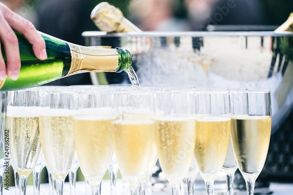 Fototapeta Champagne flows freely in festive events such as weddings and parties. The pleasure of sharing.	