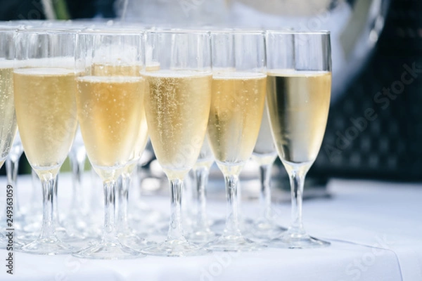 Fototapeta Champagne flows freely in festive events such as weddings and parties. The pleasure of sharing.	