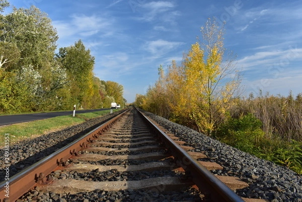 Fototapeta railway and road side by side