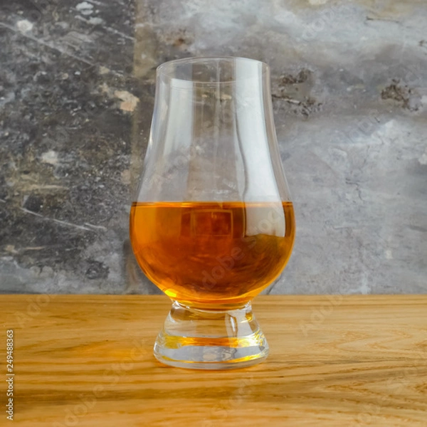 Fototapeta Irish Whiskey Glass on Wood and Slate Background Close Up Square Format