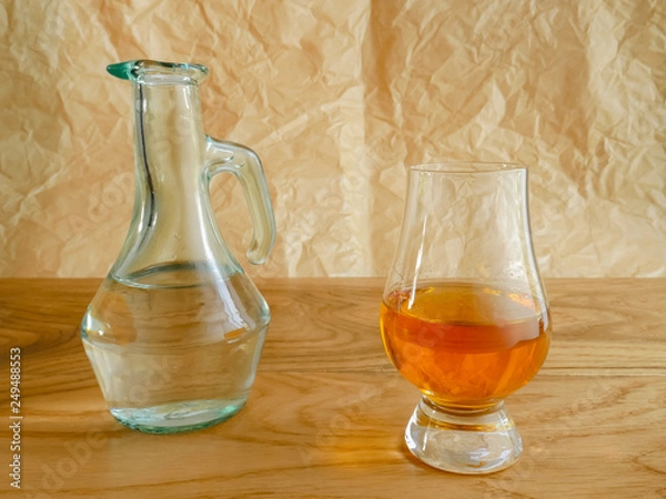 Fototapeta Irish Whiskey Glass and Water Jug on Wood and Paper Background