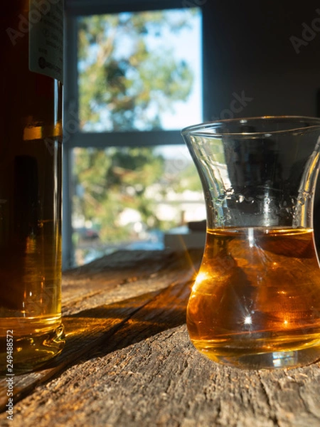 Fototapeta Unique Irish Whiskey Glass And Irish Whiskey Bottle with Sunny Irish Window Behind