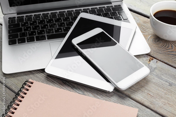 Obraz Open laptop with digital tablet and smartphone close up