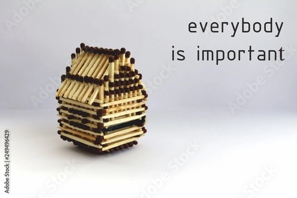 Obraz everyone is important in this world. House of matches, the architecture of matches. Slogan and motivation. Banner with motivational inscription. This can be done by everyone.