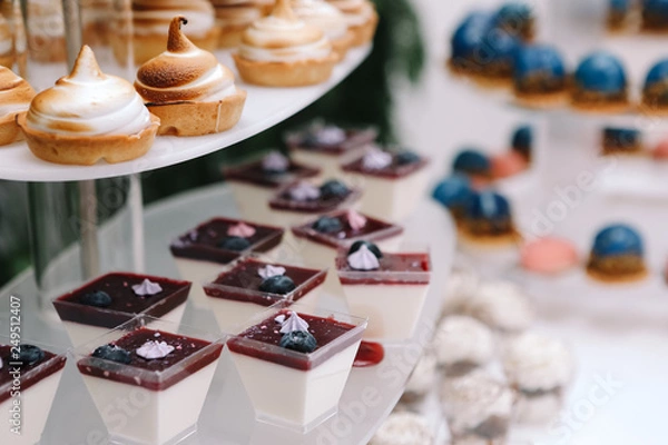 Obraz Candy bar, contains fruits, cup cakes, chocolate and another sweet desserts on the wedding. Banquet service. Catering buffet style .