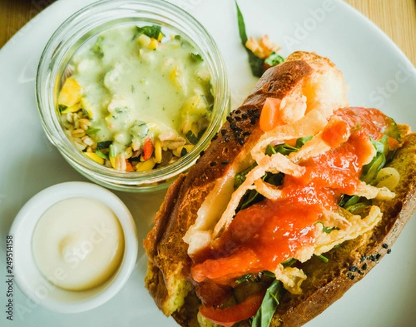 Fototapeta Breakfast sandwich with salad and sauce
