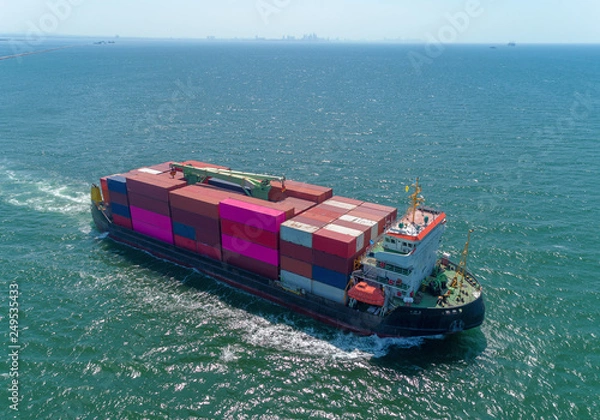 Obraz Aerial view small container ship full load container for logistic, import export, shipping or transportation.