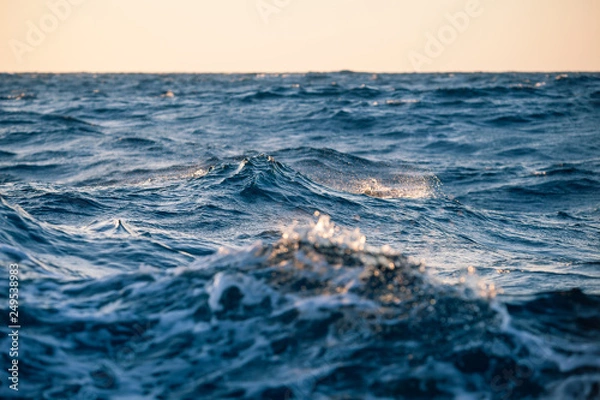 Obraz Large sea waves at sunset close up in a strong wind