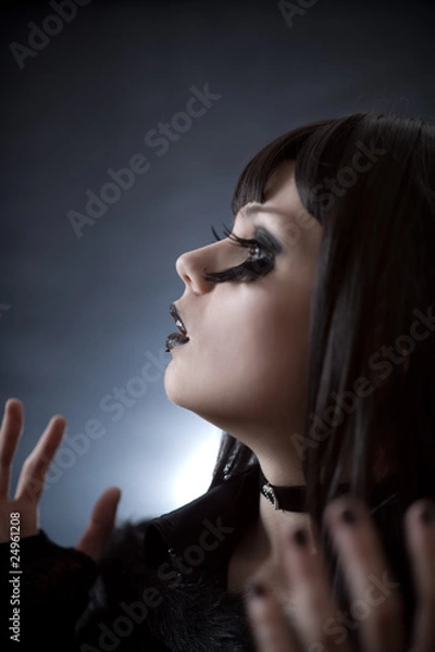 Fototapeta Expressive young woman with creative make-up and artificial eyel