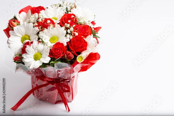 Obraz Beautiful designer bouquet of flowers in a beautiful cramped red bucket.Isolated on a white background.