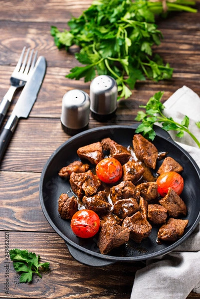 Fototapeta Roasted or stewed beef meat with tomato