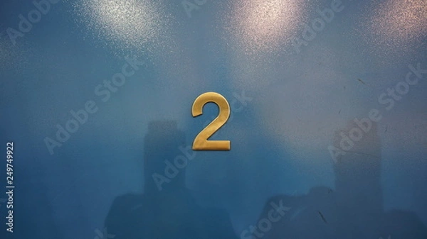 Obraz Metalic room number two on a wooden door