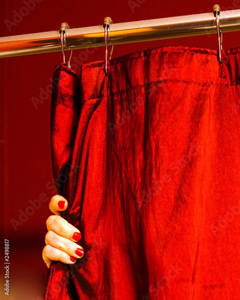 Obraz a hand with painted finger nails holding a red sho