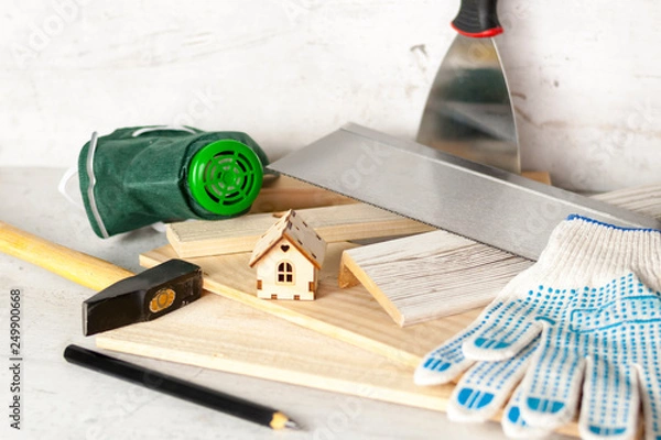 Fototapeta Model of the house on a wooden background. The concept of construction and renovation. Selective focus.