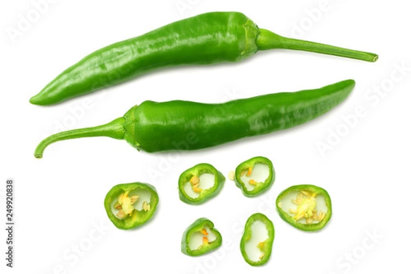 Fototapeta green hot chili peppers with slices isolated on white background top view