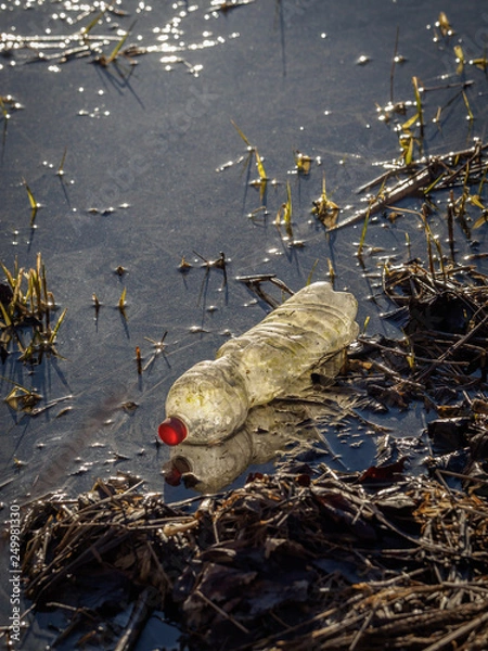 Obraz Plastic garbage pollutes a river - plastic bottle, pollution