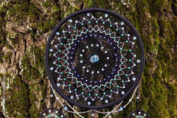 Fototapeta Handmade dream catcher with feathers threads and beads rope hanging