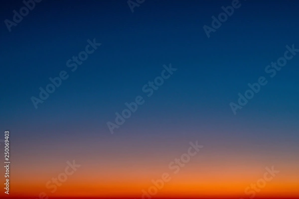 Fototapeta Sky gradient from blue to orange sunset