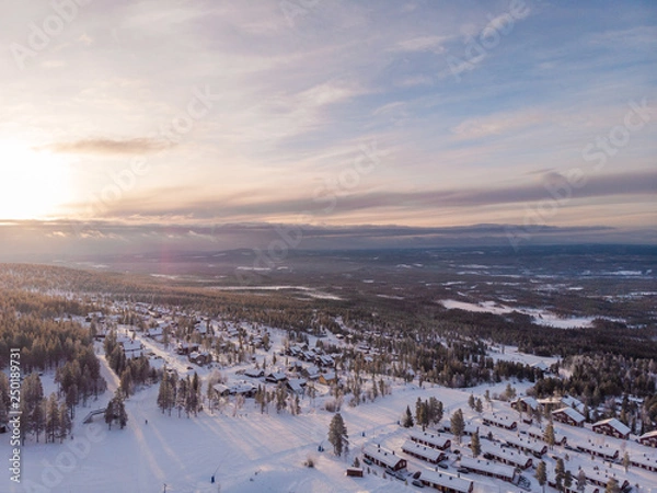 Fototapeta Panorama aerial view of Idre Fjäll cabins during sunrise a clear winter day in Sweden with one of the slopes in the photo. 