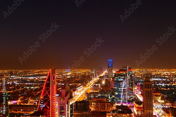 Fototapeta Panorama view to the skyline of Riyadh by night, with skyscrapers in the background and busy traffic on the streets of Riyadh, the capital of Saudi Arabia