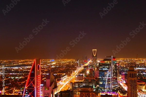 Fototapeta Panorama view to the skyline of Riyadh by night, with skyscrapers in the background and busy traffic on the streets of Riyadh, the capital of Saudi Arabia