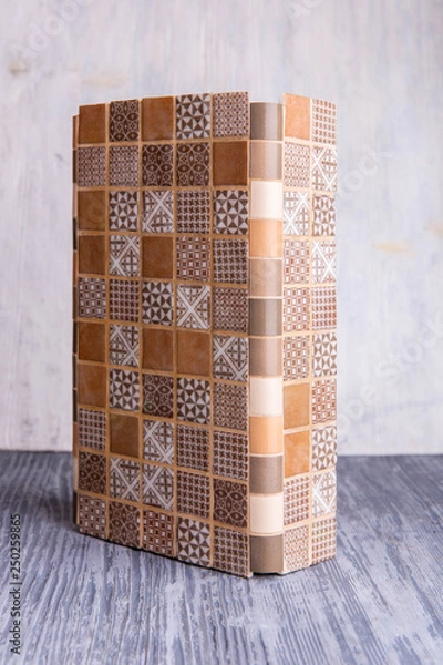 Fototapeta Sample of an angular multi-colored tile of beige and brown color