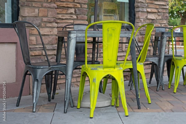 Fototapeta Table and chairs sitting outside on a cafe terrace