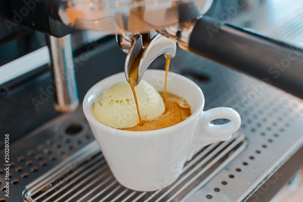 Fototapeta Affogato coffee with ice cream on a ceramic cup with coffee pouring from espresso machine