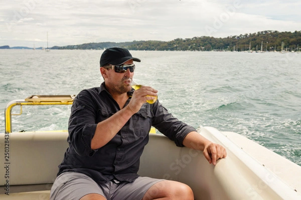 Obraz man drinking beer on a boat