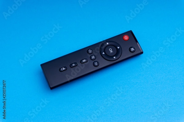 Obraz Remote control TV or radio isolated on blue background with selective focus and crop fragment