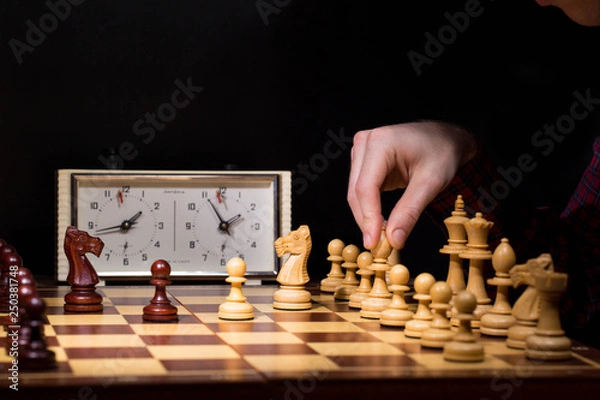 Obraz hand of businessman moving chess figure in competition success play. strategy, management or leadership concept