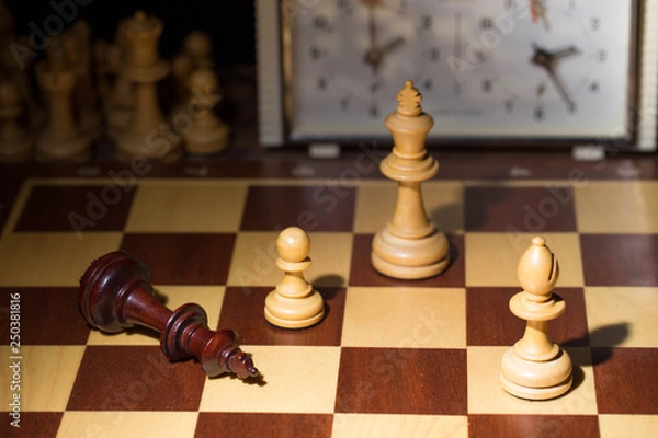 Obraz White's victory on the chessboard. The king fell.Strategy, victory, intelligence.