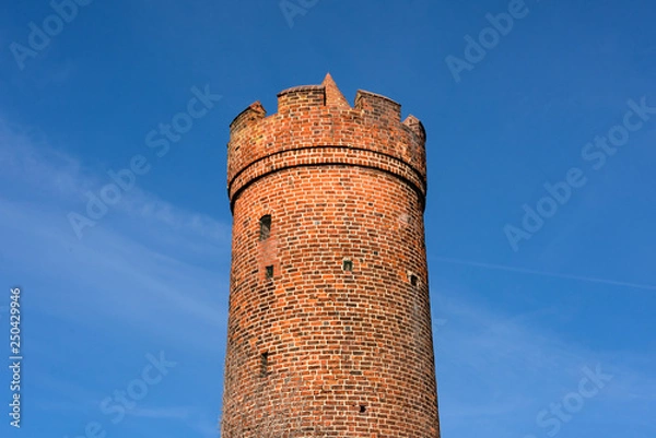 Fototapeta Germany, Brandenburg, Jueterbog, Frauentor: Upper part close up of historic round tower as part of the old city wall fortification in the German small town center - concept architecture history