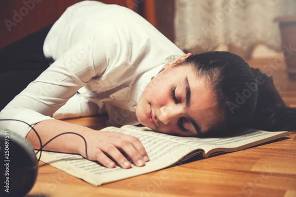 Fototapeta sleeping girl on music book
