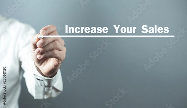 Fototapeta Man with pen write Increase Your Sales text in screen.
