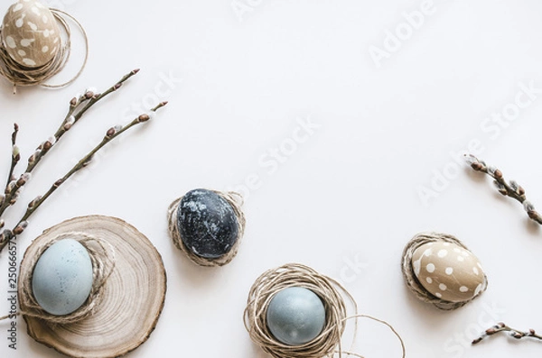 Fototapeta Pastel composition for the holiday of Easter. Colored eggs in natural colors. Background for the presentation of work or text. Top view. Copy space.  Mock-up