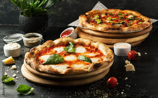 Fototapeta Delicious pizza with mozzarella on a wooden board