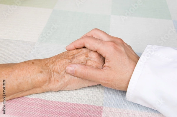 Obraz hand of a doctor holding the hand of an elderly patient