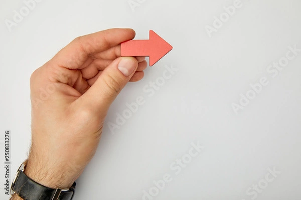 Fototapeta cropped view of man holding red pointer on grey background