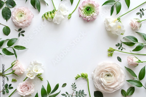 Fototapeta Frame of various delicate flowers and leaves on a white background with space for text. Beautiful floral background. Top view. Copy space. Mock-up