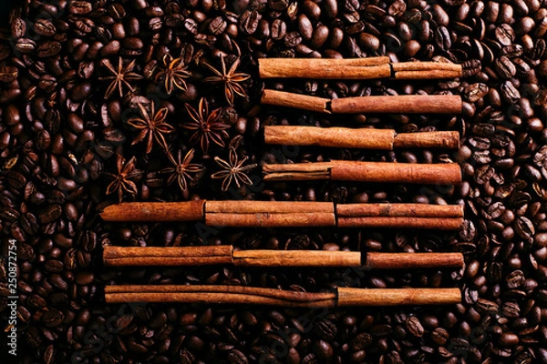 Fototapeta Coffee beans, star anise and cinnamon in the shape of the American flag. Fragrant spices for coffee drink, close-up, concept americano.