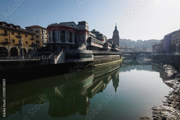 Fototapeta The Ribera market and the church of San Anton of Bilbao seen from the river