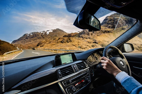 Fototapeta In Scotland on the road view from the car on Highlands
