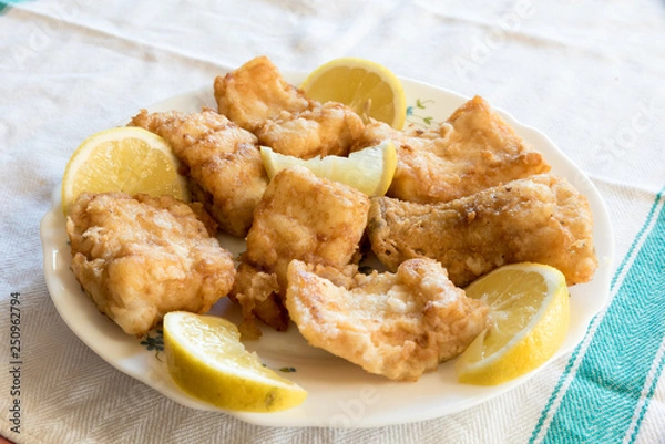 Obraz Breaded and fried Salted cod with lemon
