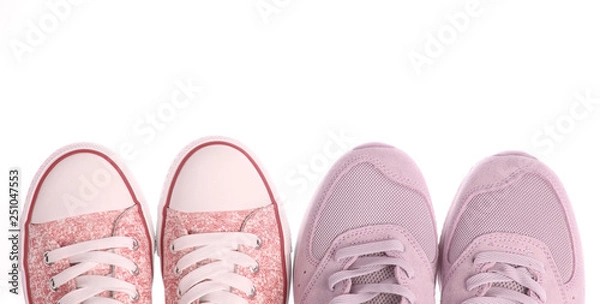 Fototapeta Two pairs of trendy sneakers isolated on white background. Top view. Copy space.