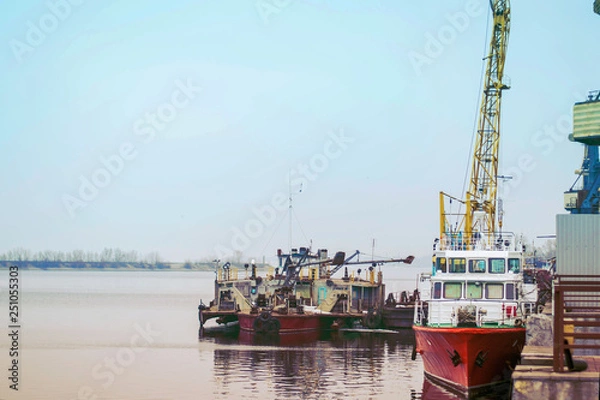Fototapeta Cargo dock ship-lifting cranes in the harbor, Cargo river port terminal container